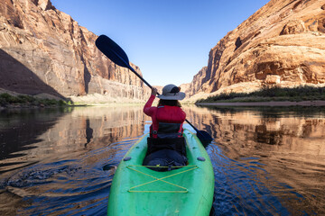 Adventurous Woman on a Kayak paddling in Colorado River. Glen Canyon, Arizona, United States of...