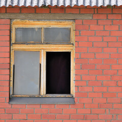 Old aged shed broken window glass, red bricks hut wall background, weathered grungy rusty dirty damaged wooden frame, textured large detailed horizontal shack backdrop, blank empty copy space closeup
