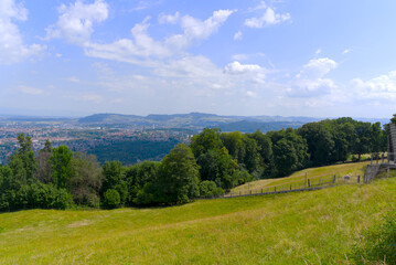 Fototapeta premium Aerial view over City of Bern and Canton Bern seen from local mountain Gurten on a blue cloudy summer day. Photo taken June 16th, 2022, Gurten, Switzerland.