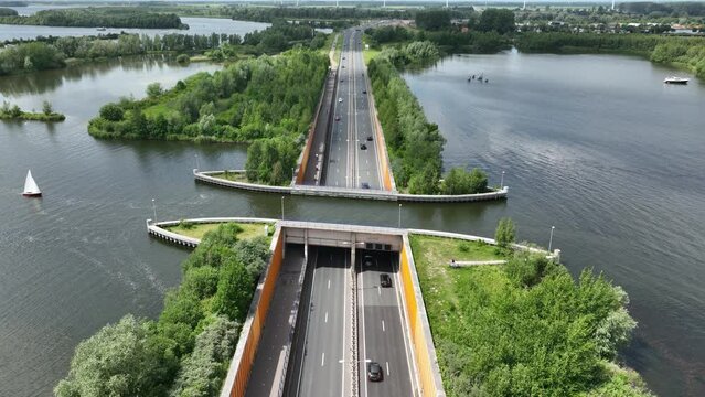 Aqueduct Veluwemeer near Harderwijk transport asphalt motorway road for traffic crossing underneath a waterway river lake infrastructure in the Netherlands. Holland