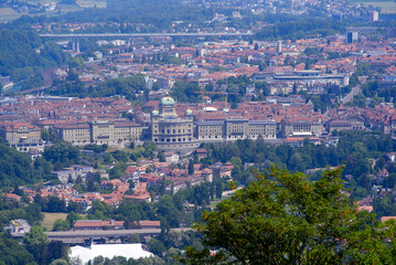 Fototapeta na wymiar Aerial view over City of Bern and Canton Bern seen from local mountain Gurten on a blue cloudy summer day. Photo taken June 16th, 2022, Gurten, Switzerland.