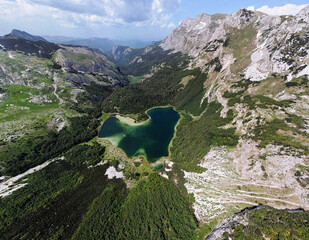 Aerial view of the heart shaped lake in Trnovacko Lake in Montenegro. Lake surrounded by mountains....
