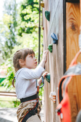 Little girl preschooler climbing on the stand