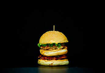 Double bacon cheese burger with black background
