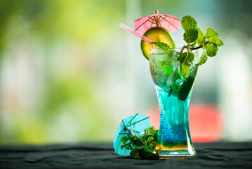 Blue mojito cocktail drink with lime
