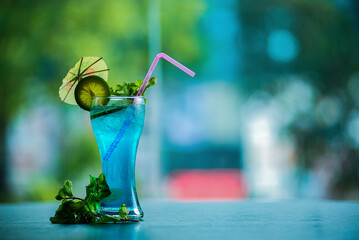 Tasty blue mojito cocktail drink with lime and mint
