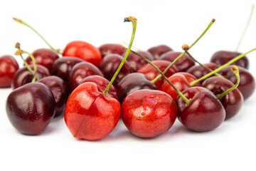 sweet cherry scattered on a white background, close-up. Seasonal berry harvest. Postcard wallpapers. The concept of vitamins, proper nutrition, agriculture, harvest. High quality photo
