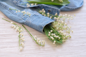 flowers, and clothes on a wooden background. Concept for organic, recycled clothes and...