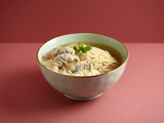 Prawn Dumpling Noodle with chopsticks served in a bowl isolated on mat side view on grey background