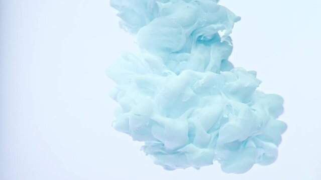 Delicate air pastels light faded blue plain background, isolated ink in water on a white background