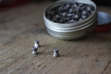 Munition for airguns / three lead pellets on a wooden prank 