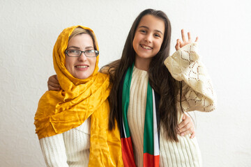 Middle eastern family with traditional emirates dresses posing in a photographic studio - Concepts...