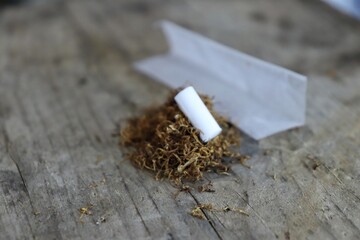 Undone cigarette on a wooden prank 