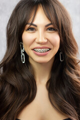 Obraz premium Beautiful brunet model woman face with brown eyes and perfect make-up . Portrait of beauty young brunet girl with pink lips. Female face with clear skin close-up. Skincare