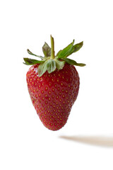 Strawberries are hanging in the air over a white background. Strawberry shadow