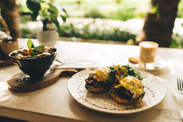Cropped image of plate with organic vegetarian food for healthy nutrition and dieting and energetic morning breakfast food for losing weight cooked with fresh delicious ingredients on table in cafe
