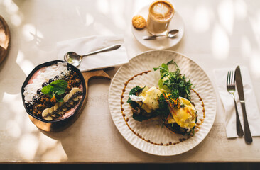 Top view of delicious morning food for keeping healthy lifestyle with fruits and granola on breakfast, overhead picture of plates with tasty food homemade prepared with fresh organic ingredients