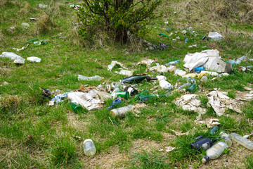 Large garbage pile on nature green grass background, global warming.