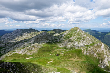Zelengora mountains in Sutjeska National Park. Small pond in the valley surrounded by mountains....