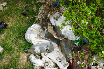 A pile of rubbish in a clearing in the countryside on a spring day, top view, close-up. Out of focus.