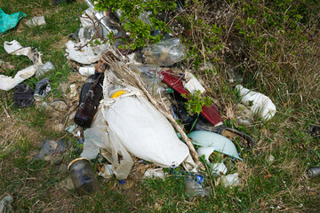 A pile of rubbish in a clearing in the countryside on a spring day. Concept of ecology.