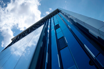 Fototapeta na wymiar Building facade with blue sky and white clouds