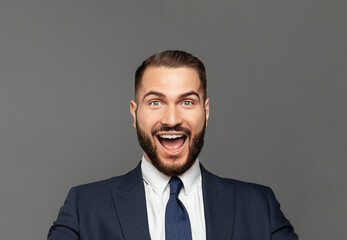 Young happy businessman with really impressive achievements screaming with happiness, male face close up