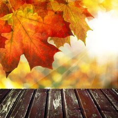 Naklejka na ściany i meble Dirty wooden table and blurred bokeh autumn background