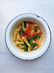 Pasta with tomato and spinach. Vegetarian healthy meal