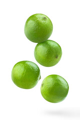 Flying delicious lime fruits, isolated on white background