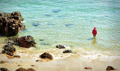 Lady in red in the ocean