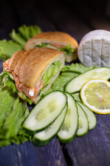 croissant with salmon, lettuce and fresh cucumber