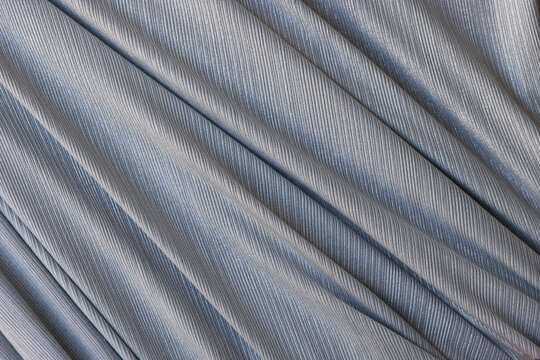 Closeup of gray synthetic fabric with folds