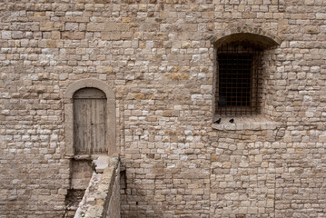 Fototapeta na wymiar Door and window at the castle of Trani, Italy