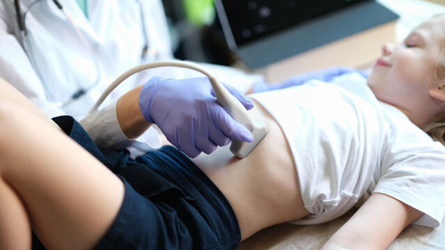 Medical examination of little girl using ultrasound equipment closeup