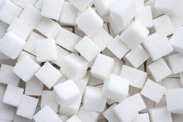 Background of refined sugar. Close-up of white sugar cubes.