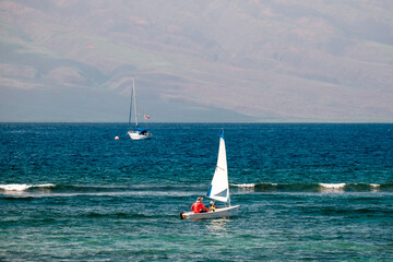 Obraz premium a father and son sailing together off the coast of Hawaii
