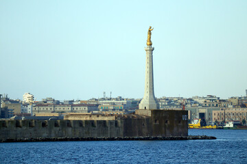 Fototapeta na wymiar Messina, Sicily (Italy): view of the port of Messina entrance with the gold Statue of the Madonna della Lettera