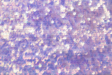 Beautiful iridescent purple color sequins textile background. Lot of copy space.