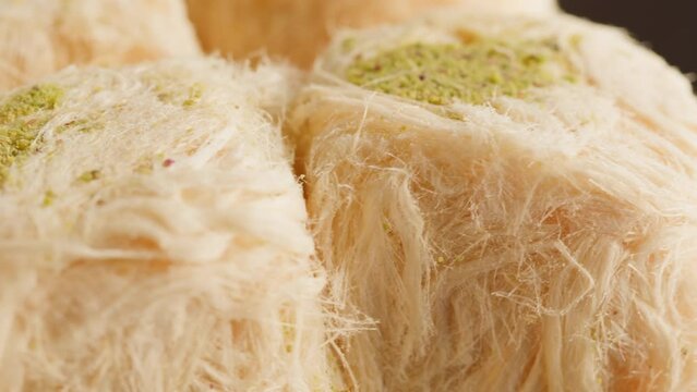 Turkish sweet food. Arabian cuisine. Pismaniye white halva close-up rotating. Middle eastern national sugar treats, dessert snack.