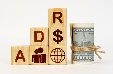 On a white surface, dollars and cubes with images and the inscription - ADR