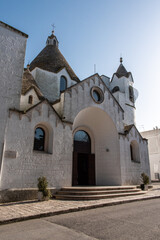 Fototapeta na wymiar Famous Trullo shaped church Sant'Antonio di Padova in Alberobello, Southern Italy