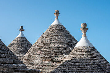 Fototapeta na wymiar Scenic roofs of houses in historic Trulli district in Alberobello, Italy
