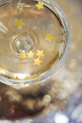 Glass of champagne with golden stars