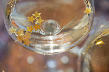 Glass of champagne with golden stars