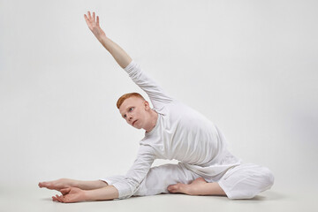 red-haired male dancer demonstrates the choreographic elements of the dance. photo shoot in the...