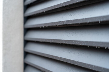 Close up of corrugated metal fence, horizontal modern metal fence with grey stucco column. Modern...