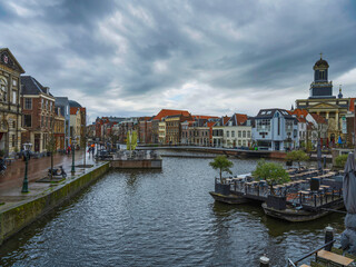 Fototapeta na wymiar Canal side Dutch architecture and boat restaurant in Leiden, Netherlands