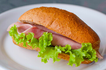 Breakfast, wholemeal bread sandwich with ham and lettuce.