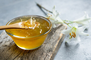 Fresh White Madonna lilly jam in glass bowl on white rustic table